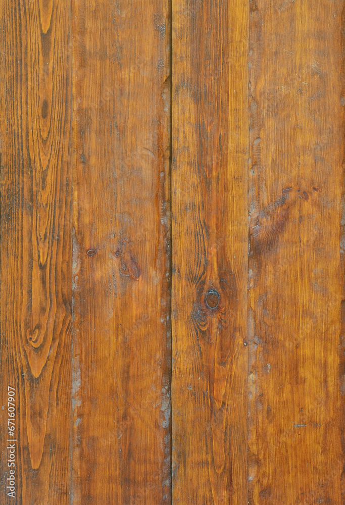 Texture of the old wooden wall from a number of scratched planks that are varnished Texture of the old wooden wall from a number of scratched planks that are varnished