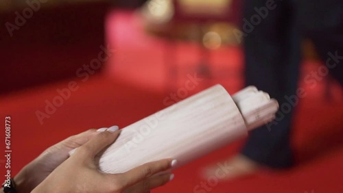 woman's hand shakes a wooden fortune telling numbers on it. photo