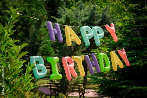 Happy Birthday! Children's decoration with glowing lights, birthday garland, different color of balloons. Decorated photo zone. Festive decorative elements, photo area.
