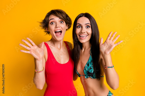 Photo of crazy surprised two girls impressed summer season shopping discounts isolated over bright color background