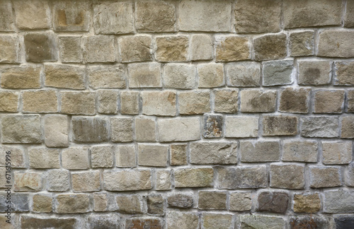 Texture of old grey stone wall with various stones.