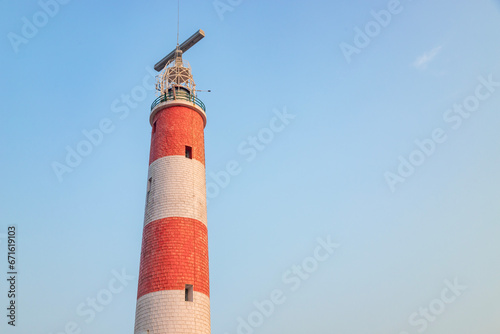 Gopalpur lighthouse with red and white stripes in cloudless blue sky gopalpur near Gopalpur Fort, odisha, India