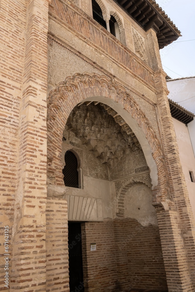 A fragment of the traditional Mudejar ornament exterior of a historic building in Granada, Spain