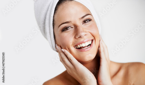 Smile, portrait and woman with towel for skincare in a studio for health, wellness and natural face routine. Happy, beauty and young female model with facial dermatology treatment by gray background.