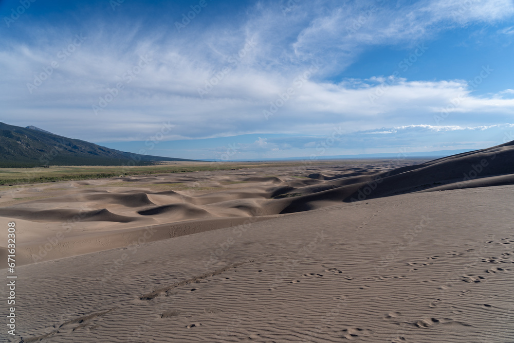 Fototapeta premium Great Sand Dunes National Park in Colorado on a sunny summer day, with mountains in the background