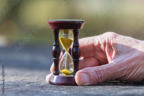 Wooden hourglass in the park. Photo