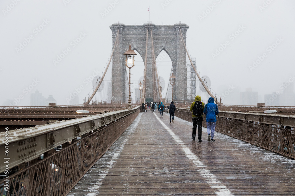 Fototapeta premium Snowflakes fall at Brooklyn Bridge, New York