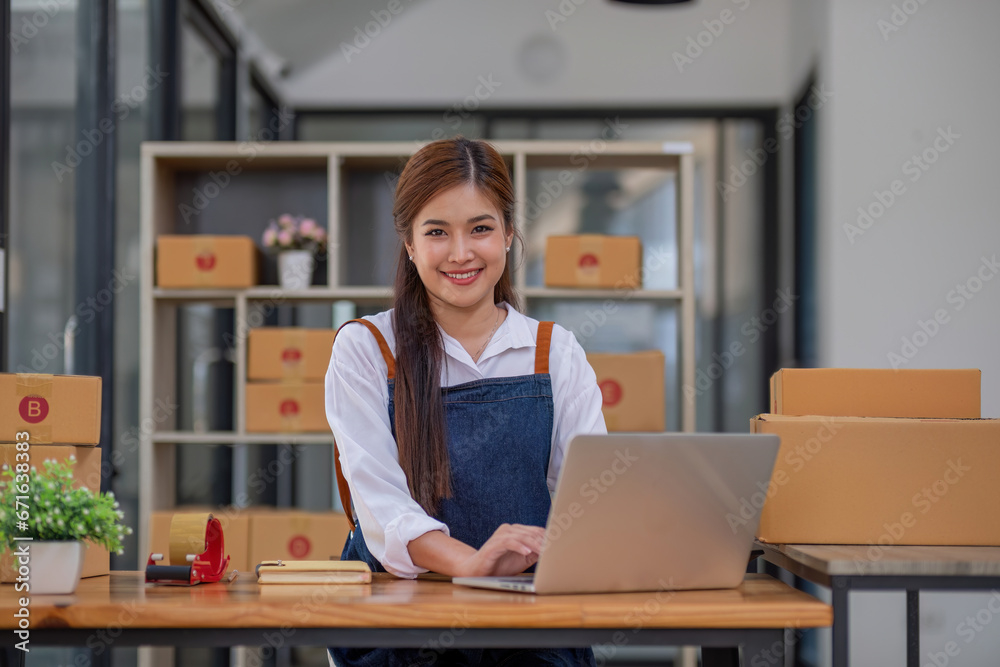 Startup small business entrepreneur SME, asian woman packing cloth in box. Portrait young Asian small business owner home office, online sell marketing delivery, SME e-commerce telemarketing concept Startup small business entrepreneur SME, asian woman packing cloth in box. Portrait young Asian small business owner home office, online sell marketing delivery, SME e-commerce telemarketing concept