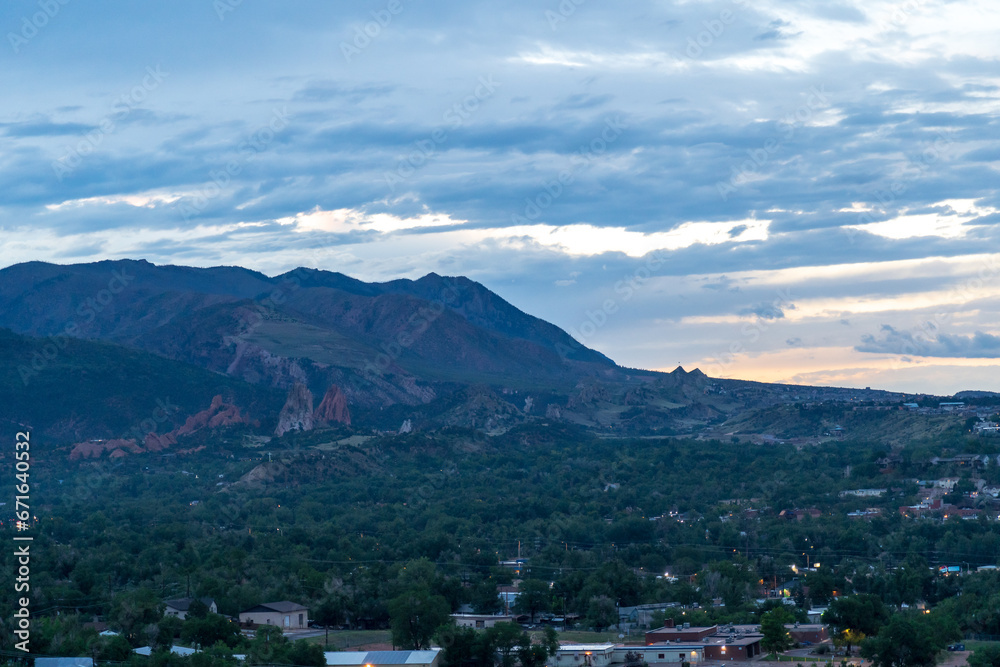 A view of Garden of the Gods from afar at sunset on a cloudy evening in Colorado Springs, CO
