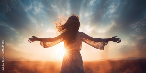 a woman with her arms outstretched in front of the sun