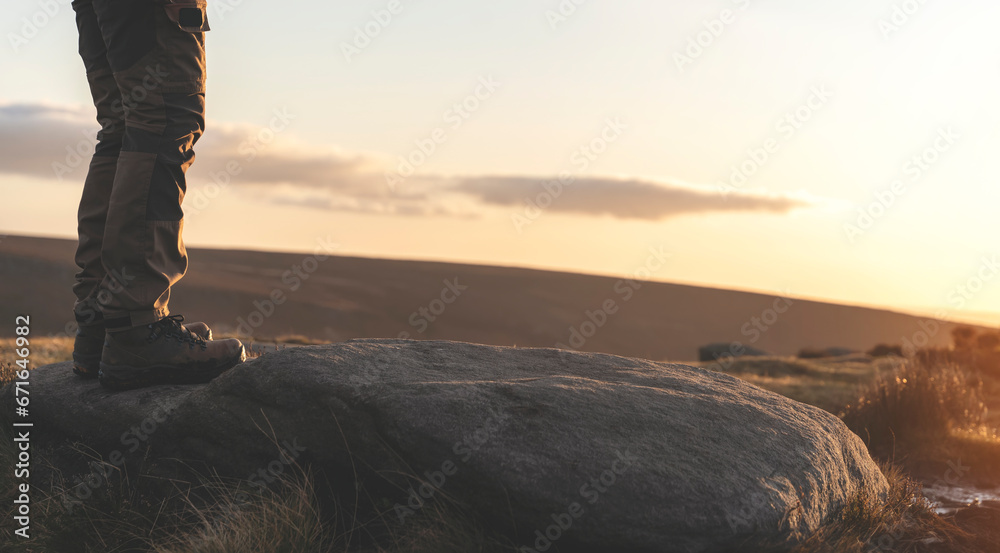man in special boots walking in the mountains reaching the destination and on the top of mountain in Peak District at sunset on autumn day Travel Lifestyle concept man in special boots walking in the mountains reaching the destination and on the top of mountain in Peak District at sunset on autumn day Travel Lifestyle concept