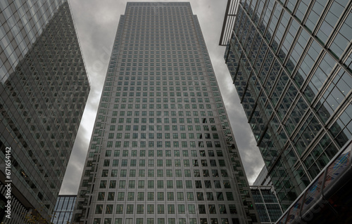 Upward view of Skyscrapers in the business district area of One Canada Square in Canary Wharf. Tall structure architecture in the capital city. Architectural exterior view  Copy space  Selective focus