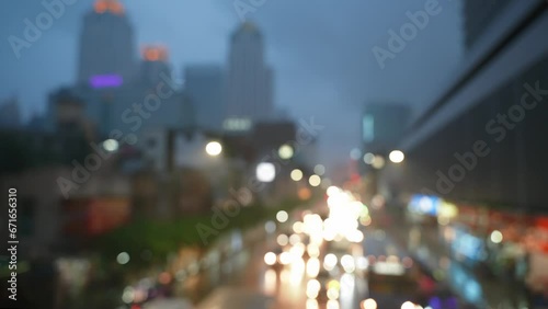 Blurred cityscape on a rainy night. Colorful bokeh of traffic jam light on the city road