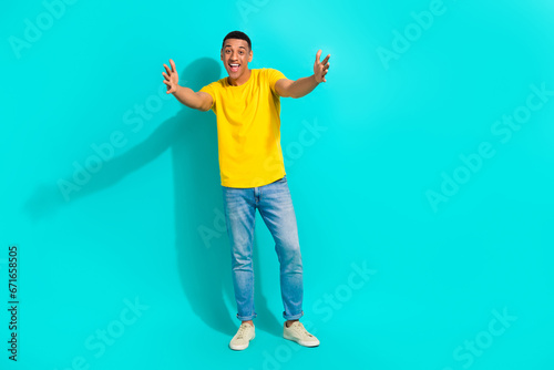 Full body photo of positive excited person raise opened arms welcome invite you empty space isolated on turquoise color background © deagreez