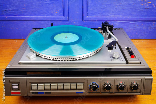 Vintage turntable vinyl record player with turquoise vinyl