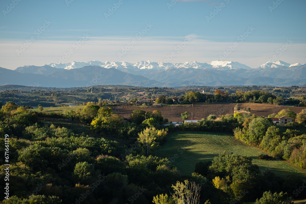 Countryside landscape in the Gers department in France with the Pyrenees mountains in the background
