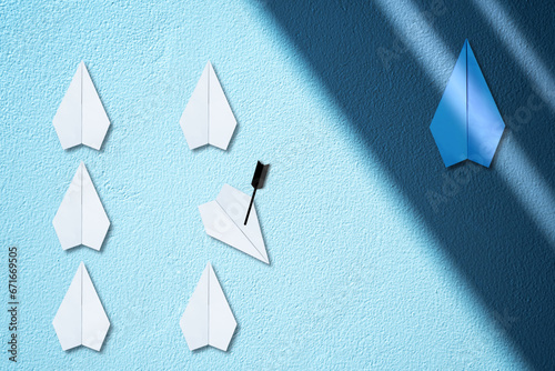 Hidden blue paper plane flying under the the shade versus white paper plane flying in the light. Secrete of business and success concept. Dark horse of competition and the falling competitor.
