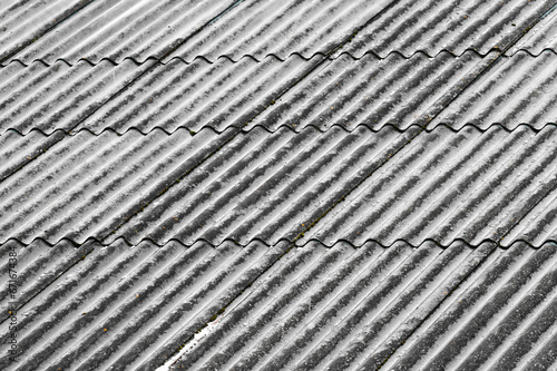 Background of snowy slate roof with wave texture © Niko_Dali