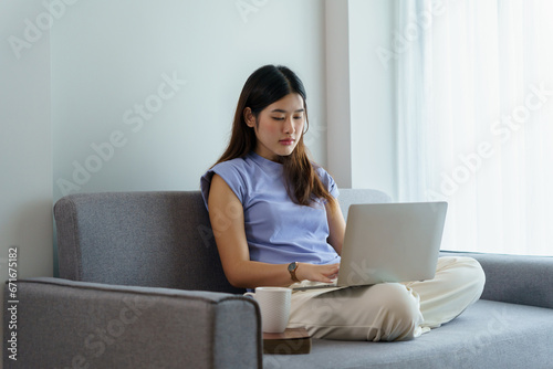 Happy beautiful Asian Woman. Business woman working from home with laptop Financial Home work space concept.