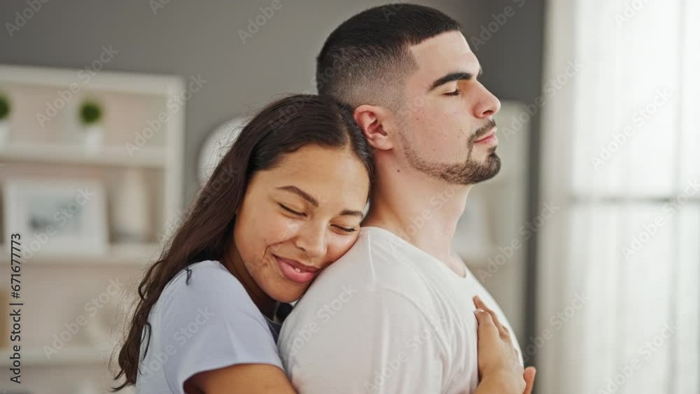 Beautiful couple hugging each other standing together smiling at home Beautiful couple hugging each other standing together smiling at home