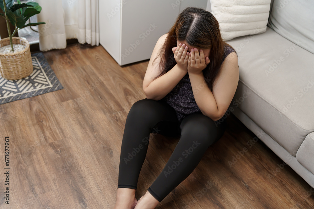 Sad Overweight plus size woman thinking about problems on sofa upset girl feeling lonely and sad from bad relationship or Depressed woman disorder mental health