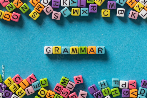 grammar word from multicolored letters on blue,  learn english language concept