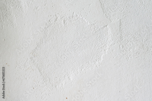 An old white wall with texture is decorated with cement mortar
