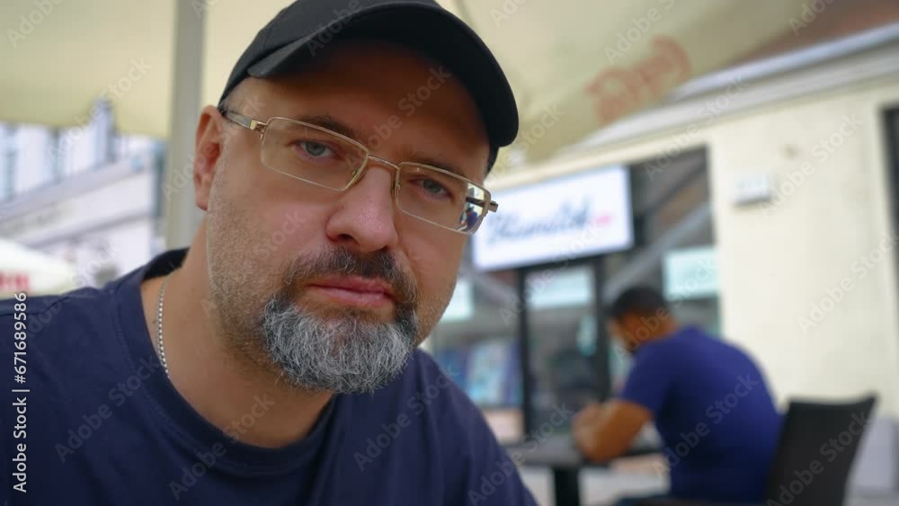 Caucasian man eating breakfast at street cafe portrait. Street unhealthy food, fast pace of life, snack in public place in city Caucasian man eating breakfast at street cafe portrait. Street unhealthy food, fast pace of life, snack in public place in city