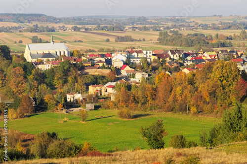 Autumn landscape with a panorama of the town of Bodzentyn, Swietokrzyskie province, Poland. Scenic view of valley and colorful fields on the hillside.