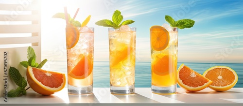 Citrusy summer cocktails and refreshing drinks for a summer party with low alcohol mocktails and palm shadow on white background