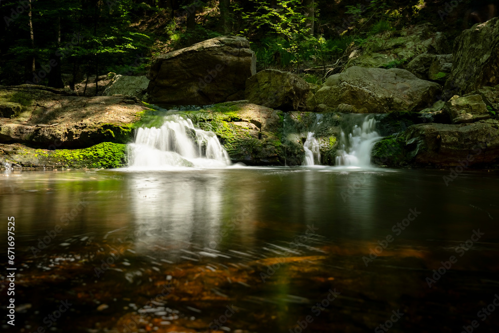 Pool with Waterfall and Running Water between rocky mountains Pool with Waterfall and Running Water between rocky mountains
