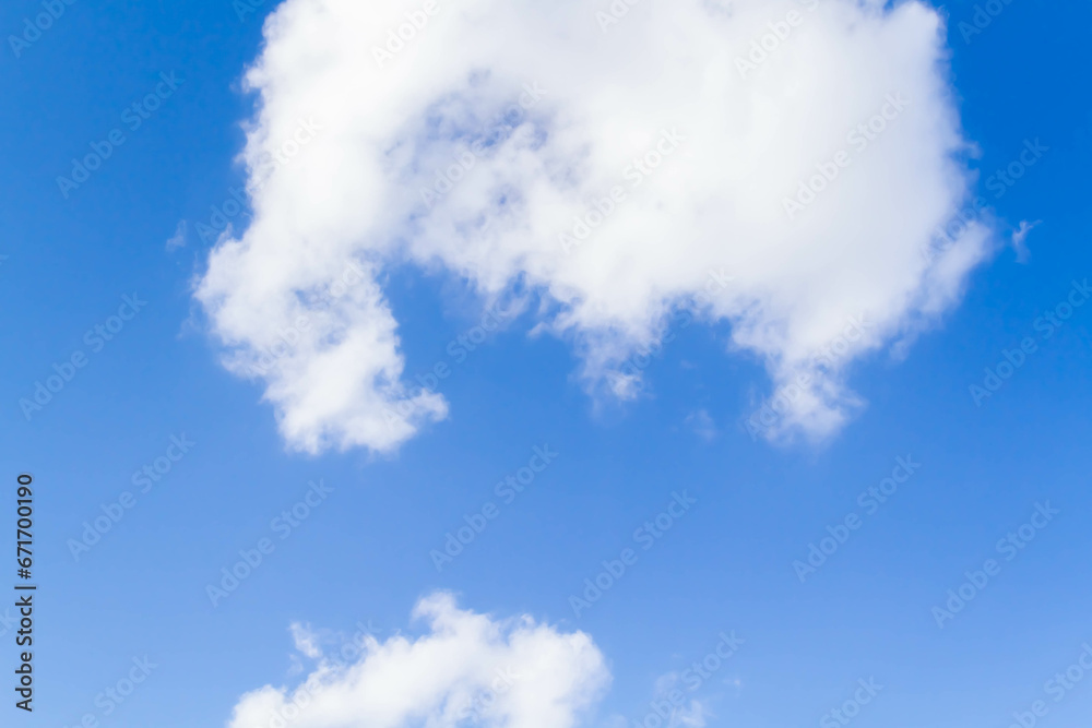 White airy beautiful clouds in a bright blue sky. Clear sunny weather. The concept of environmental safety and cleanliness. White airy beautiful clouds in a bright blue sky. Clear sunny weather. The concept of environmental safety and cleanliness.
