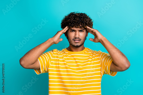 Photo portrait of handsome young guy touch head suffer migraine wear trendy striped yellow outfit isolated on aquamarine color background