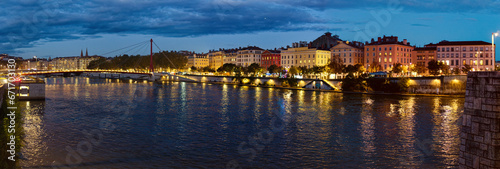 Night panorama or the quary of the Celestins and Justice Palace bridge over the Saone river, Lyon, France