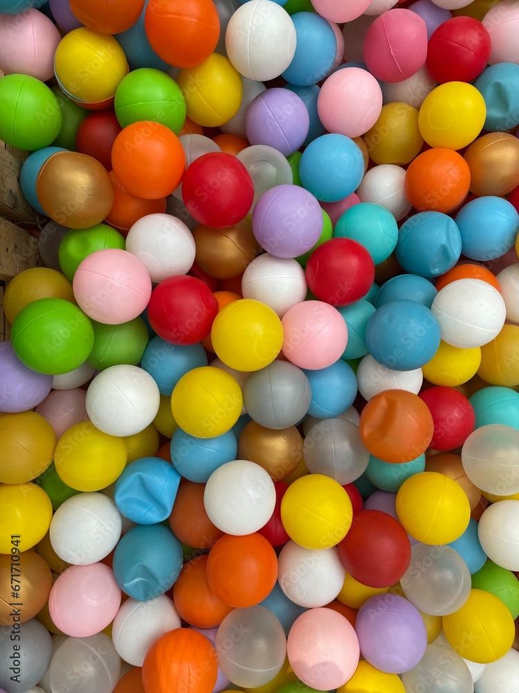 A pile of colorful plastic balls as a design background A pile of colorful plastic balls as a design background