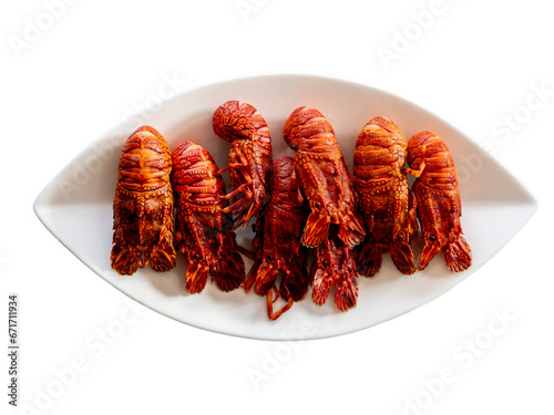 boiled European locust lobsters (Scyllarus arctus) on a plate on transparent background - highly valued seafood from northern Spain commonly known as 