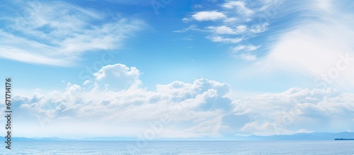 The sky with clouds is adorned by a vast expanse of blue sea