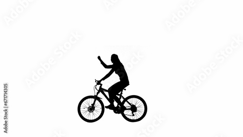 Fototapeta Naklejka Na Ścianę i Meble -  Portrait of female model. Black silhouette of girl showing victory gesture riding a bike. Isolated on white background with alpha channel.