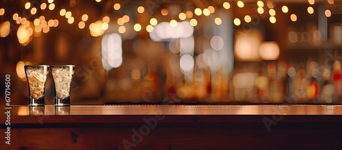 The sign hanging in the bar with one glass intentionally blurred is adorned with twinkling Christmas lights