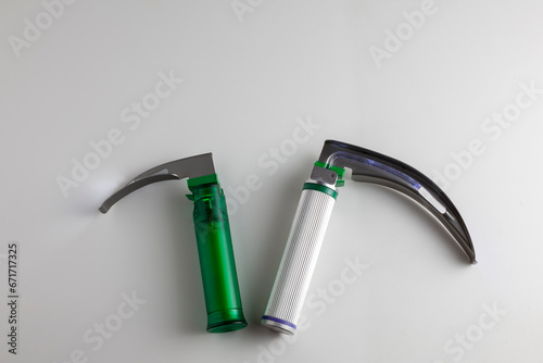 On the white table there is a child and an adult laryngoscope. Copy space. photo