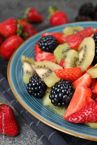 Plate of delicious fresh fruit salad on table  closeup