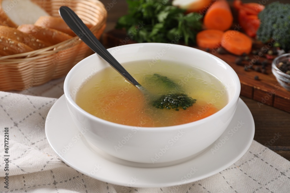 Tasty soup with vegetables in bowl served on wooden table, closeup Tasty soup with vegetables in bowl served on wooden table, closeup
