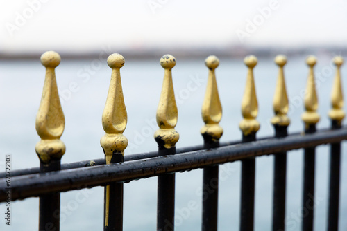 Metal fence against the background of water after rain.