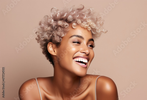 pretty smiling girl beauty female gen z model with short blonde hair beautiful face healthy skin and tattoo looking at camera wearing white top isolated at beige background