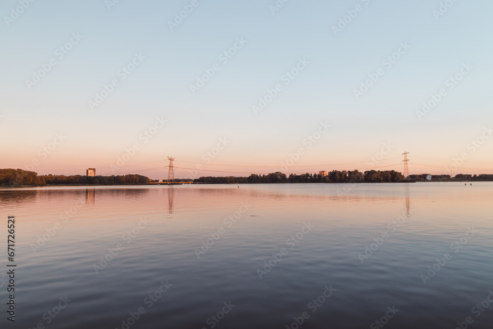 Colorful water surface and sky during sunset in summer in Almere, Netherlands