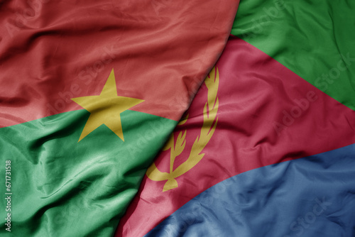big waving national colorful flag of burkina faso and national flag of eritrea .