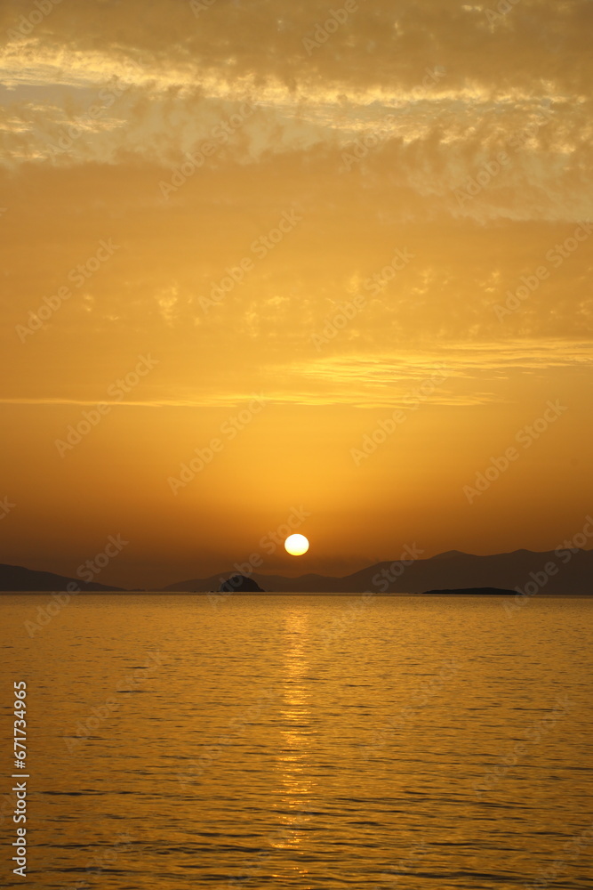 Naklejka premium sunset on the beach. Seaside town of Turgutreis and spectacular sunsets. Selective Focus.