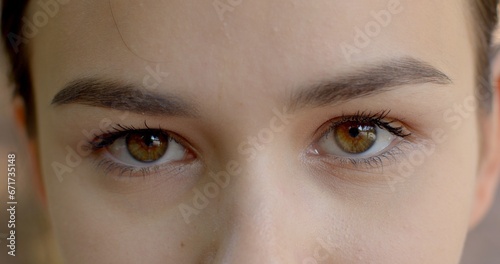 Close-up woman eyes, sense of intimacy and connection between viewer and subject, dark color of the iris. powerful symbol of a person's identity eyes close up. Recognizable features of an individual.