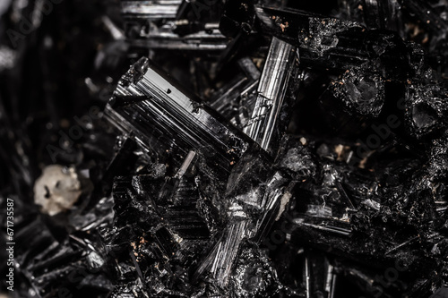 Tourmaline black crystals. Gems. Mineral crystals in the natural environment. Texture of precious and semiprecious stones. Seamless background with copy space colored shiny surface of precious stones.