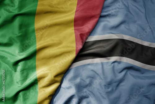 big waving national colorful flag of mali and national flag of botswana .